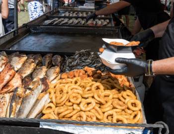 A food vendor serving fish and fried seafood at the 2025 Hilton Head Island Seafood Festival