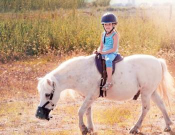 A young girl riding a pony at Lawton Stables on Hilton Head Island