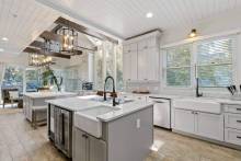 A modern kitchen with white countertops and appliances at 11 East Wind, a vacation rental on Hilton Head Island