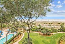 A view of a beach, courtyard, and pool from a vacation rental on Hilton Head Island