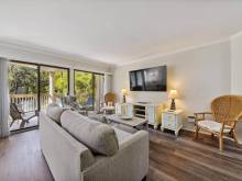 The living room with access to the deck of a vacation rental on Hilton Head Island